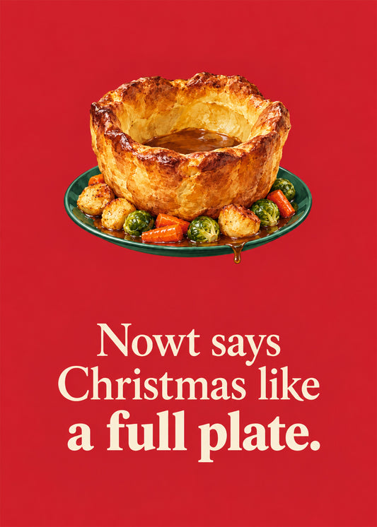 Funny Christmas card showing a photoreal giant Yorkshire pudding filled with gravy on a plate of roasties, sprouts, by Gigglz