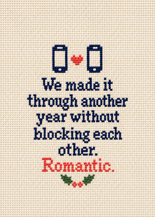 Funny Christmas card showing cross-stitch style navy lettering with two stitched phones, a heart and holly, by Gigglz